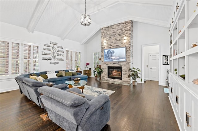 living room with dark hardwood / wood-style flooring, a fireplace, high vaulted ceiling, and a chandelier