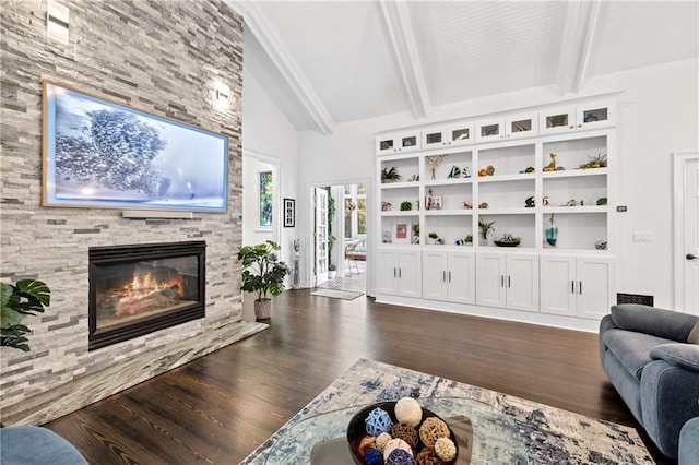 living room with a stone fireplace, lofted ceiling with beams, and dark wood-type flooring