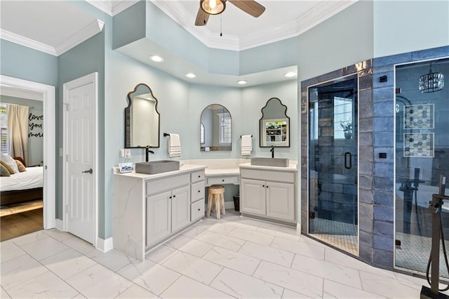 bathroom with vanity, ceiling fan, ornamental molding, and a shower with shower door