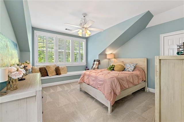 bedroom with ceiling fan, light carpet, and vaulted ceiling