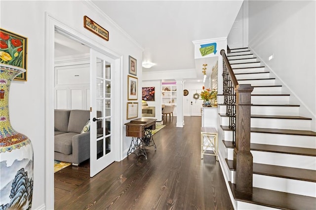 interior space with french doors, dark hardwood / wood-style floors, and ornamental molding