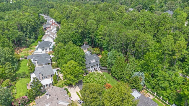 bird's eye view featuring a forest view and a residential view