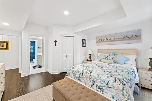 bedroom with dark hardwood / wood-style flooring and a closet