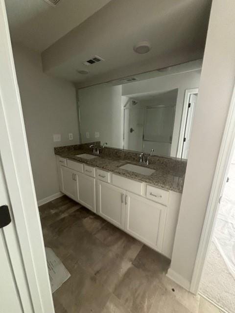 bathroom featuring vanity and a shower with shower door