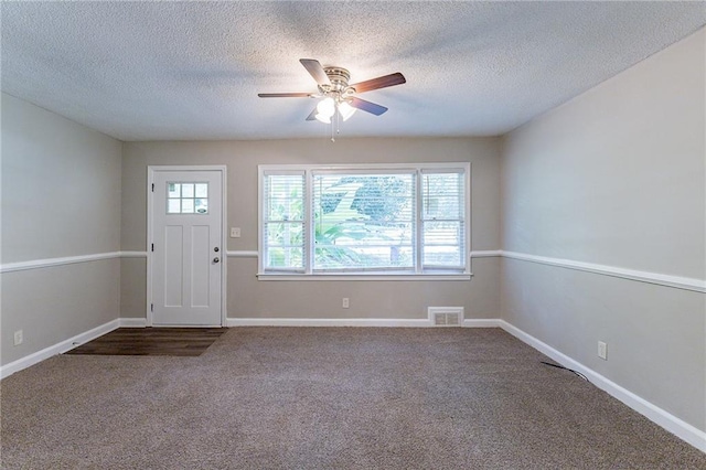 carpeted entryway with plenty of natural light, baseboards, and visible vents