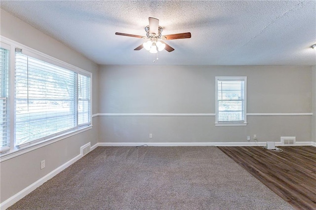 unfurnished room with visible vents, baseboards, and ceiling fan