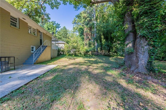 view of yard with stairway and cooling unit