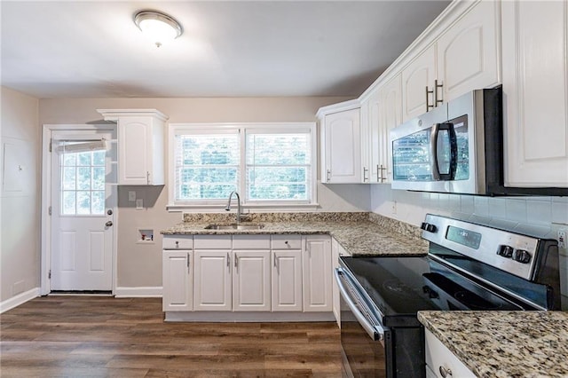 kitchen with sink, dark hardwood / wood-style floors, appliances with stainless steel finishes, and white cabinets