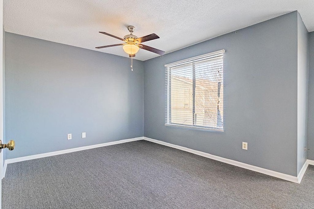 carpeted spare room with ceiling fan and a textured ceiling