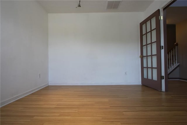838 Roxholly Ln, Buford, GA 30518 - empty room with light wood finished floors, stairway, and baseboards