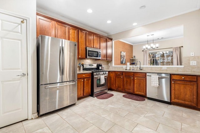 kitchen featuring ornamental molding, decorative backsplash, hanging light fixtures, and appliances with stainless steel finishes