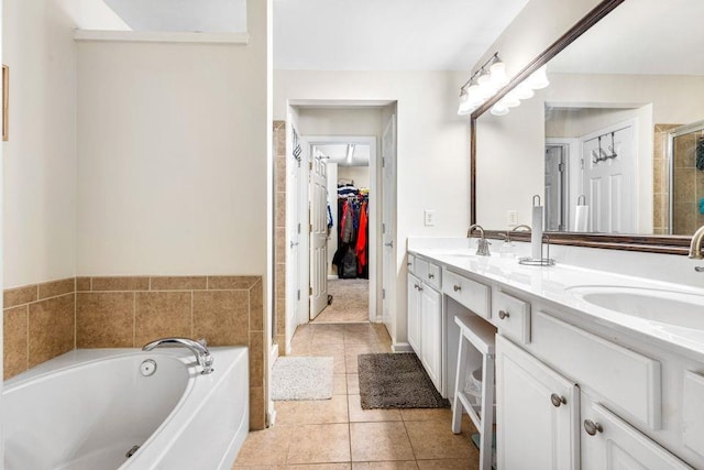 bathroom featuring tile patterned floors, vanity, and shower with separate bathtub