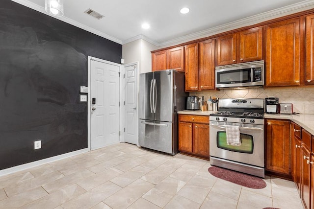 kitchen featuring crown molding, decorative backsplash, light tile patterned floors, and stainless steel appliances