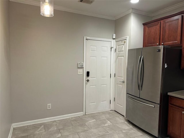 kitchen featuring ornamental molding, freestanding refrigerator, and baseboards