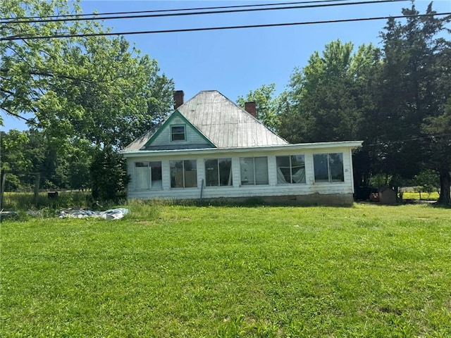 391 Rudy York Rd NW, Cartersville, GA 30121 - back of property with a chimney, a lawn, and metal roof