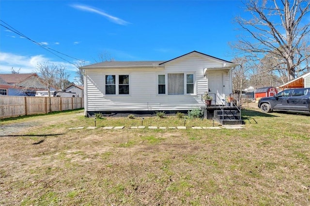 view of front of house featuring a front yard and fence