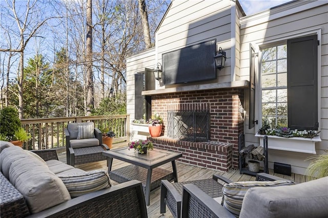 deck featuring an outdoor living space with a fireplace