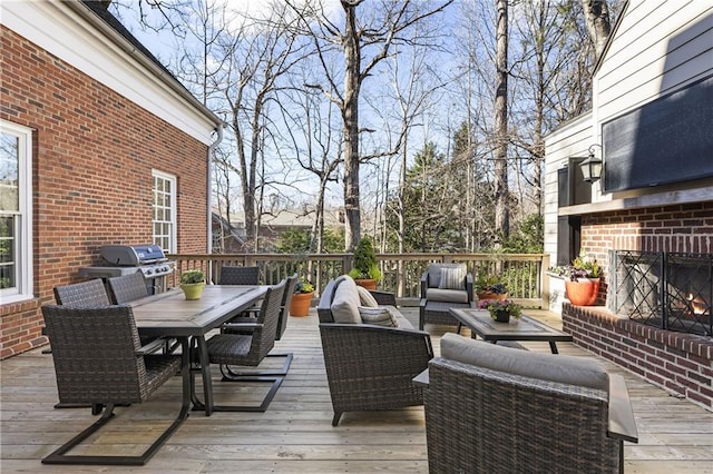 deck featuring outdoor dining space, an outdoor living space, and area for grilling