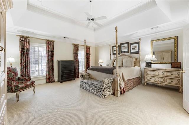 bedroom with multiple windows, a raised ceiling, and ornamental molding