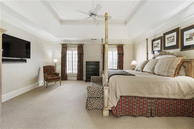 bedroom featuring a tray ceiling, baseboards, and ornamental molding