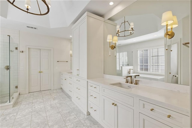 full bath with a stall shower, visible vents, a chandelier, and vanity