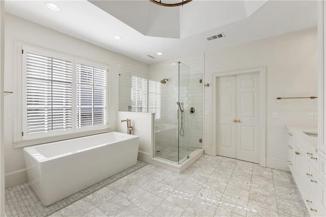 full bathroom featuring a freestanding tub, visible vents, recessed lighting, a shower stall, and vanity