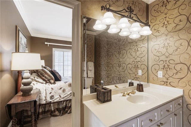 bathroom with connected bathroom, ornamental molding, and vanity