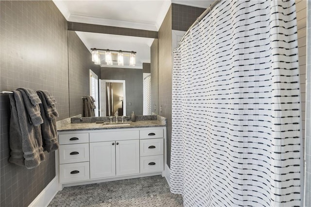 bathroom with speckled floor, tile walls, and ornamental molding