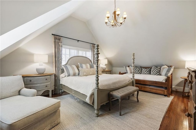 bedroom with a notable chandelier, vaulted ceiling, and hardwood / wood-style flooring