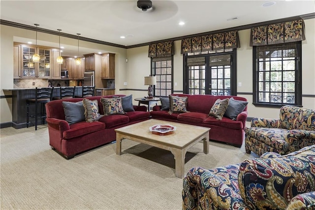 living area with recessed lighting, baseboards, and ornamental molding