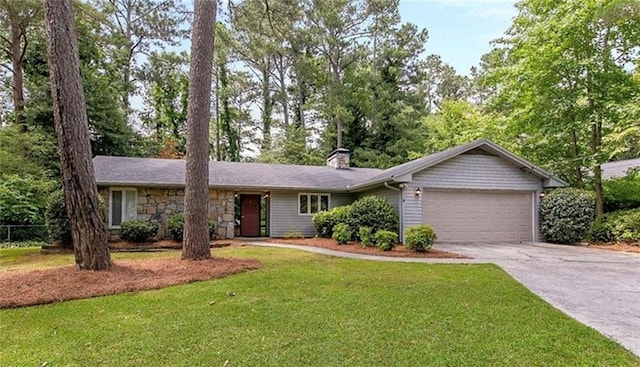 ranch-style home featuring a front lawn and a garage