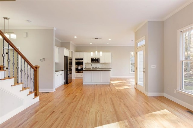 unfurnished living room with crown molding, stairway, baseboards, and light wood finished floors