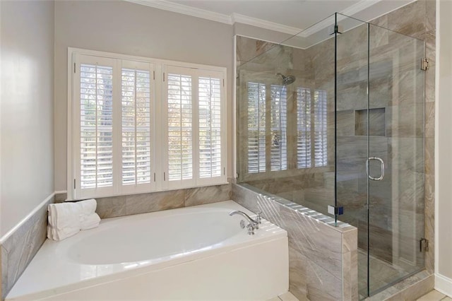 full bathroom featuring ornamental molding, a shower stall, and a bath