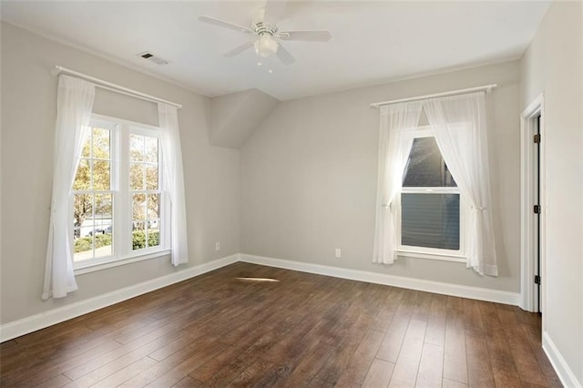 bonus room with visible vents, baseboards, dark wood-type flooring, and ceiling fan