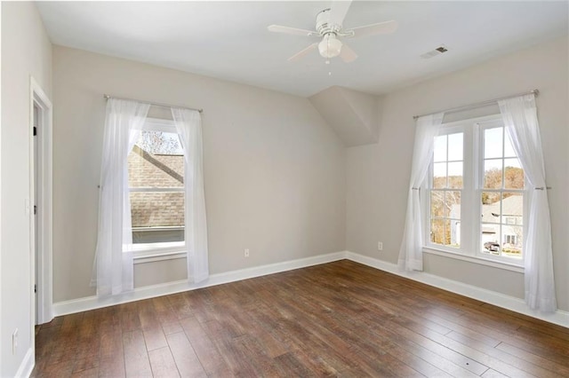 interior space with visible vents, a ceiling fan, baseboards, and wood-type flooring