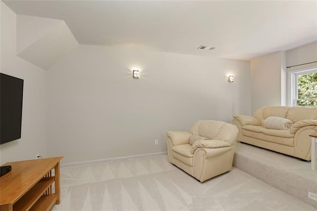 living area with light carpet, visible vents, and baseboards