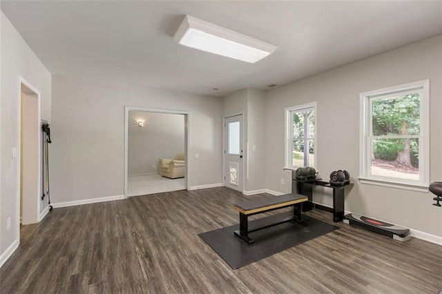 workout room featuring baseboards and wood finished floors