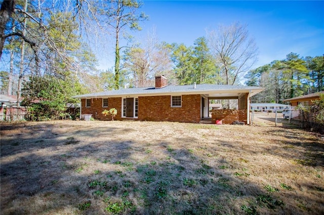 rear view of house with a lawn