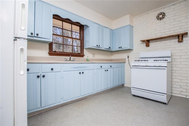 kitchen with white appliances, brick wall, blue cabinets, and sink