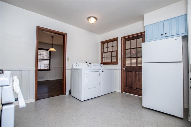 clothes washing area with washing machine and clothes dryer