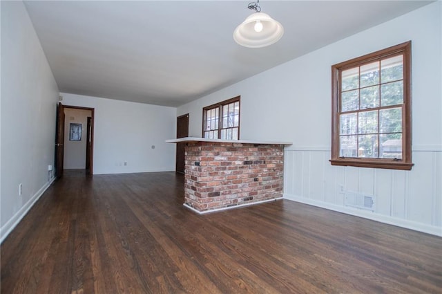 unfurnished living room with dark hardwood / wood-style floors