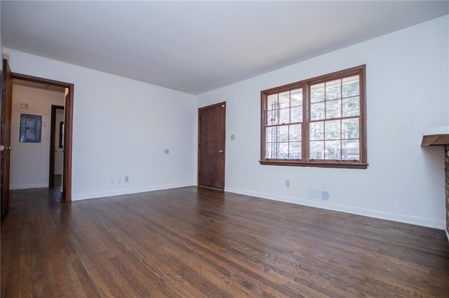 unfurnished living room with dark wood-type flooring