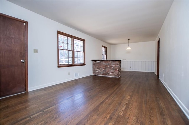 unfurnished living room featuring dark hardwood / wood-style floors