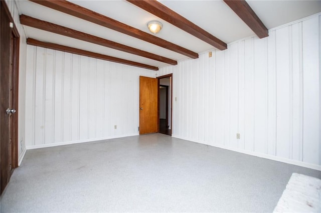 empty room with beamed ceiling