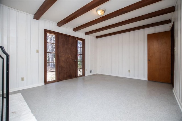 foyer entrance featuring beamed ceiling