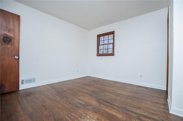 unfurnished room featuring dark hardwood / wood-style flooring