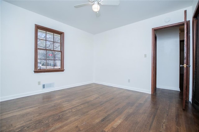 spare room featuring dark hardwood / wood-style floors and ceiling fan