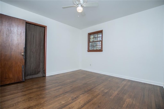 spare room with dark wood-type flooring and ceiling fan