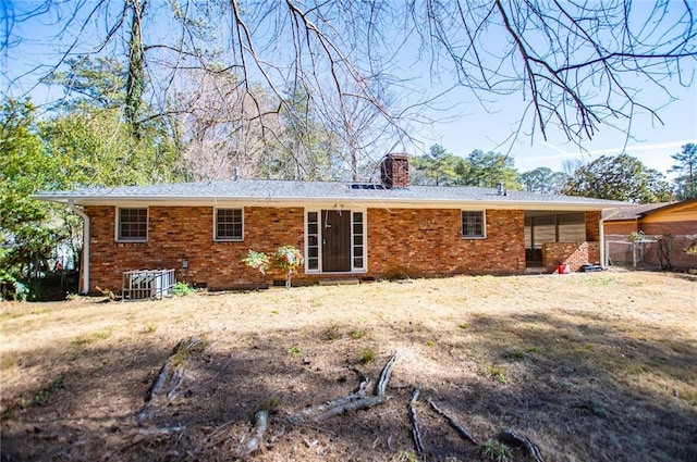 rear view of property with a yard