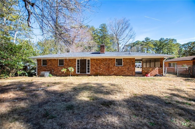 rear view of house featuring a yard